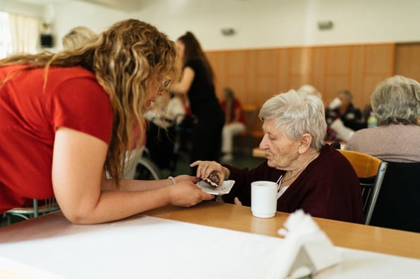 A Woman Eating at a Table