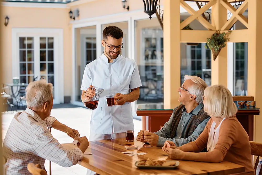 Assisted living dining staff serving residents — food service in senior living communities